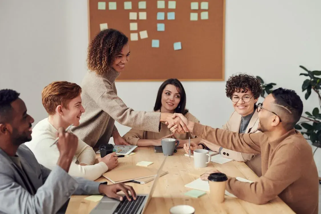 An employer team collaborating around a table, representing global mobility management for international workforce moves in 2027