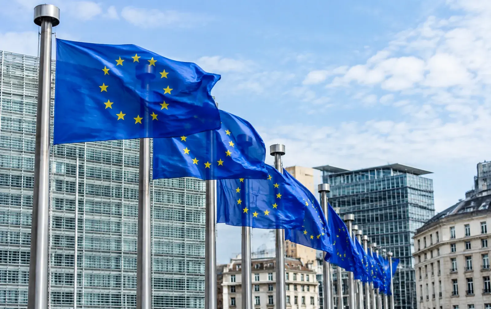 European Union flag and government buildings representing the 2026 reform of A1 certificate rules for posted workers.