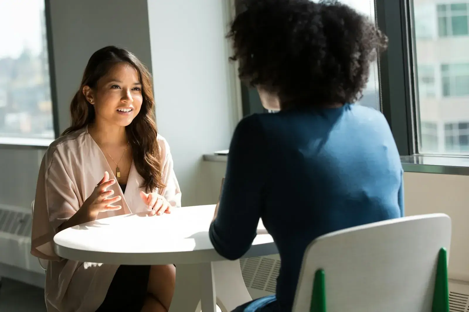 Diverse business team collaborating around a table with documents, representing a single point of accountability across the global mobility assignment lifecycle.