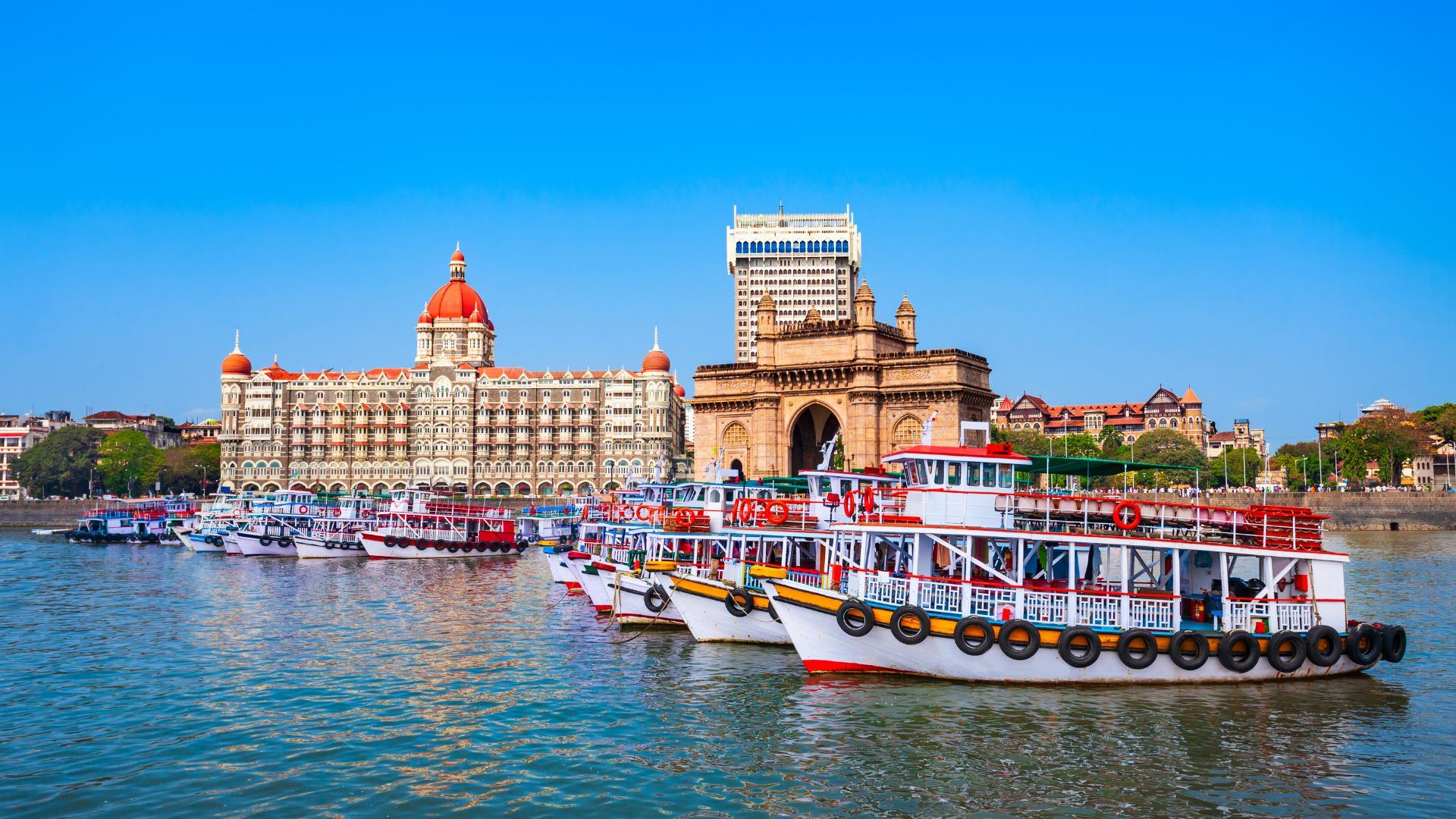 Gateway of India and the Taj Mahal Palace hotel on the Mumbai waterfront with harbour boats
